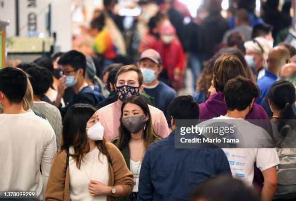 People walk and gather inside Grand Central Market while many wear face coverings on March 3, 2022 in Los Angeles, California. Los Angeles County is...