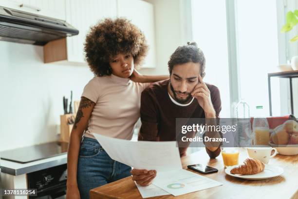 couple at home analyzing utility bills - french budget stock pictures, royalty-free photos & images