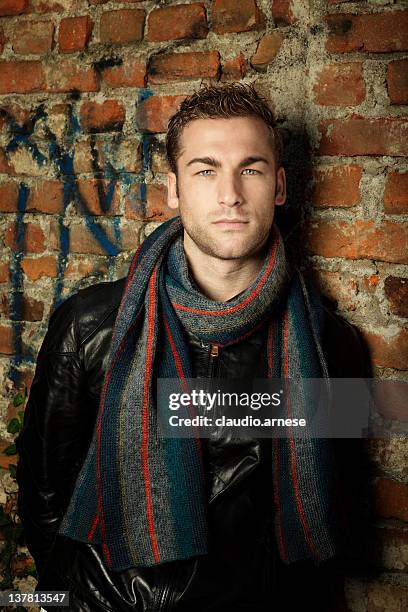 male beauty portrait with wall background. color image - smirking stock pictures, royalty-free photos & images