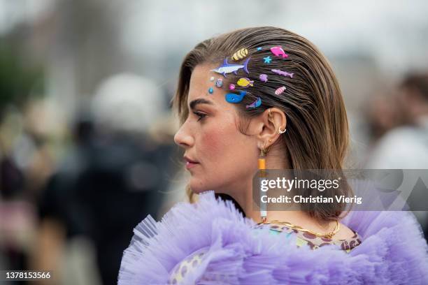 Clara Berry seen with hair clips and cigarette earring wearing purple ruffled overall, pink bag, shoes with animal print outside Coperni during Paris...