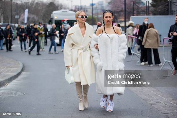 Leonie Hanne seen wearing white sunglasses latte belted coat, bag, over knees boots & Jaime Xie wearing white off shoulder teddy coat, heels outside...