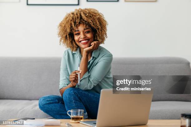 home office: portrait of a cheerful woman working from home - beautiful hair at home stock pictures, royalty-free photos & images