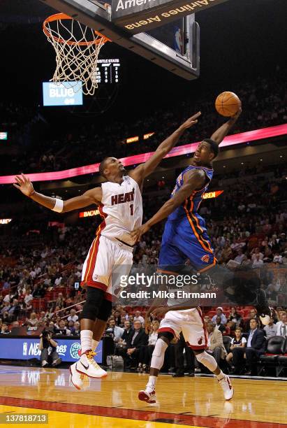 Iman Shumpert of the New York Knicks tries to dunk over Chris Bosh of the Miami Heat during a game at American Airlines Arena on January 27, 2012 in...