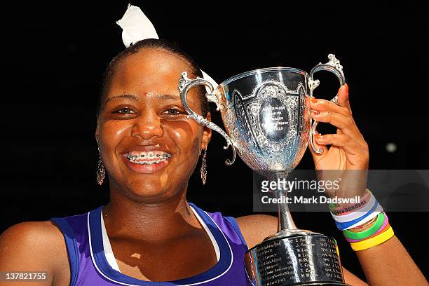 Taylor Townsend of the United States of America poses with the winner's trophy after winning the junior girls final match against Yulia Putintseva of...
