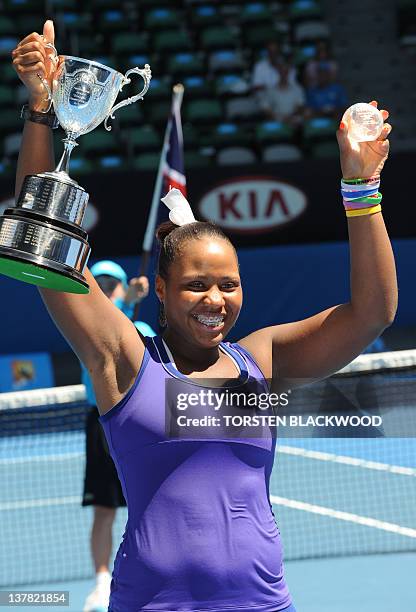 Taylor Townsend of the US poses with the trophy after victory in her girls singles final match against Yulia Putintseva of Russia on the thirteenth...