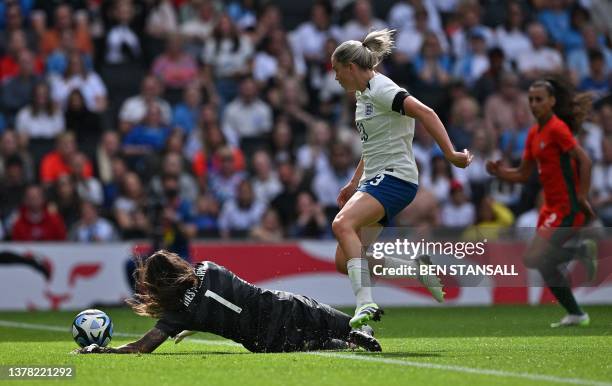 England's striker Alessia Russo jumps over Portugal's goalkeeper Ines Pereira but fails to score during the International football friendly match...