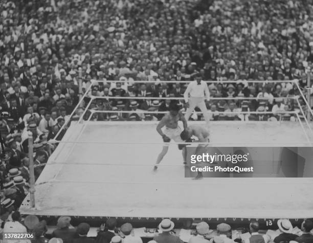 American boxer Jack Dempsey fights French boxer Georges Carpentier as referee Harry Ertle looks on, at Boyle's Thirty Acres, Jersey City, New Jersey,...