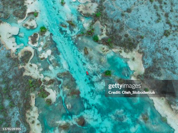 aerial view of  red canoe on bacalar lagoon in mexico - mayan riviera stock pictures, royalty-free photos & images