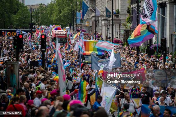 Participants carry rainbow flags and march during The Pride in London Parade in London, UK, on Saturday, July 1, 2023. Pride flags are flying over...