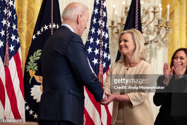 President Joe Biden shakes hands with Former Fox News anchor Gretchen Carlson speaks during an event for the signing of H.R. 4445, the “Ending Forced...