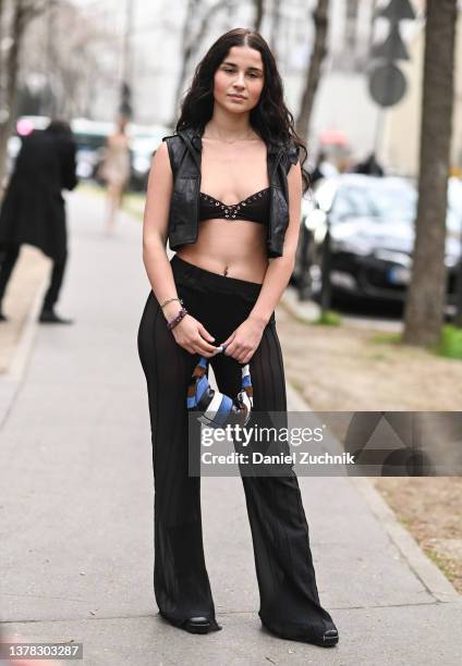 Guest is seen wearing a black vest, black bralette, black pants outside the Ludovic de Saint Sernin show during Paris Fashion Week A/W 2022 on March...