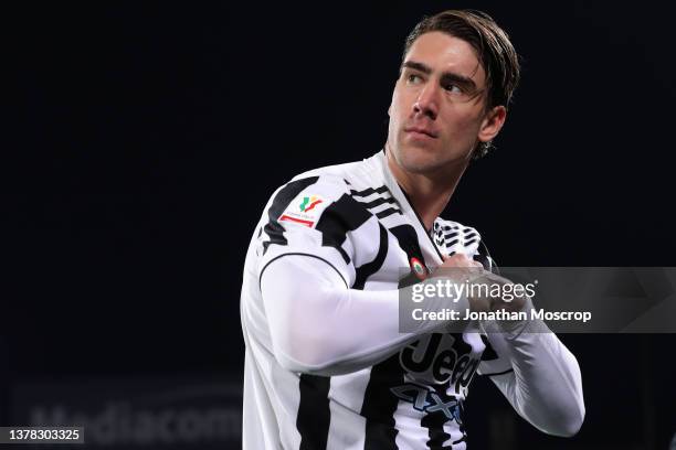 Dusan Vlahovic of Juventus applies ointment to his chest as he looks over his shoulder prior to kick off in the Coppa Italia Semi Final 1st Leg match...