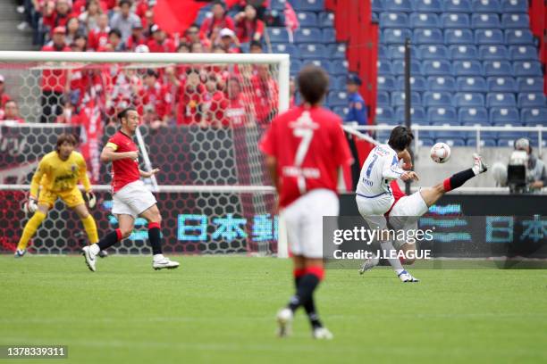 Yasuhito Endo of Gamba Osaka scores his side's third goal during the J.League J1 match between Urawa Red Diamonds and Gamba Osaka at Saitama Stadium...