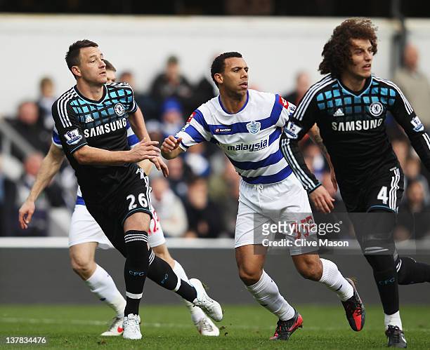John Terry of Chelsea prepares to defend a cross with Anton Ferdinand of Queens Park Rangers during the FA Cup with Budweiser Fourth Round match...
