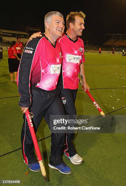 Stuart MacGill and Brett Lee of the Sixers celebrate after the Sixers defeated the Scorchers at the T20 Big Bash League Grand Final match between the...