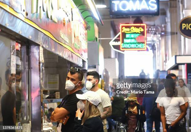 People gather inside Grand Central Market on March 3, 2022 in Los Angeles, California. Los Angeles County is expected to drop its indoor mask mandate...
