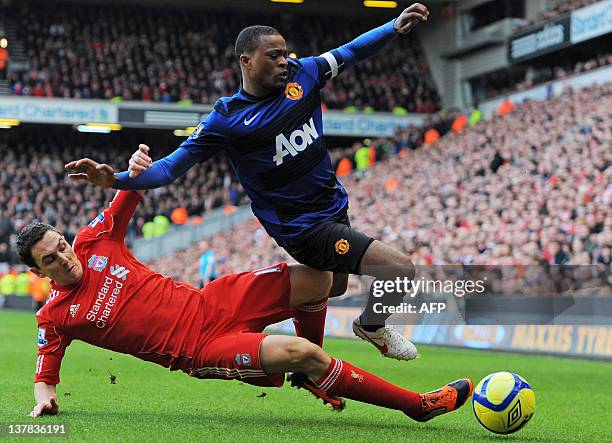 Liverpool's English midfielder Stewart Downing vies with Manchester United's French defender Patrice Evra during the English FA Cup fourth round...