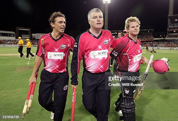 Stephen O'Keefe Stuart MacGill and Steve Smith of the Sixers leave the field after the teams win during the T20 Big Bash League Grand Final match...