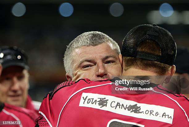 Stuart MacGill of the Sixers has tears in his eyes as he is hugged by Dominic Thornley after the T20 Big Bash League Grand Final match between the...