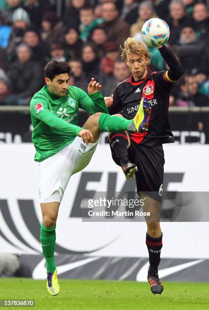 Mehmet Ekici of Bremen and Simon Rolfes of Leverkusen battle for the ball during the Bundesliga match between SV Werder Bremen and Bayer 04...