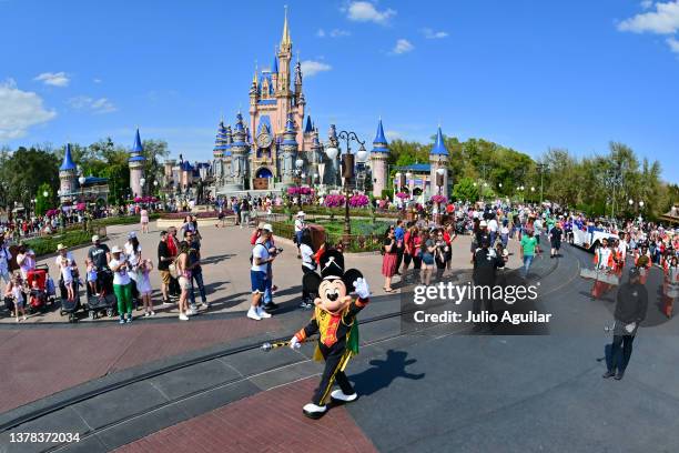 Mickey Mouse waves to fans during a parade at Walt Disney World Resort on March 03, 2022 in Lake Buena Vista, Florida.