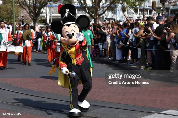 Mickey Mouse waves to fans during a parade at Walt Disney World Resort on March 03, 2022 in Lake Buena Vista, Florida.