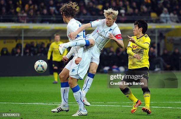 Shinji Kagawa of Dortmund challenges Andreas Beck and Jannik Vestergaard of Hoffenheim during the Bundesliga match between Borussia Dortmund and 1899...