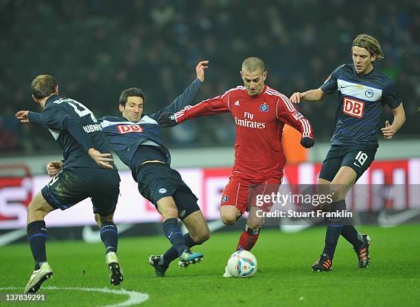 Mladen Petric of Hamburg is challenged by Andre Mijatovic and Peter Niemeyer of Berlin during the Bundesliga match between Hertha BSC Berlin and...