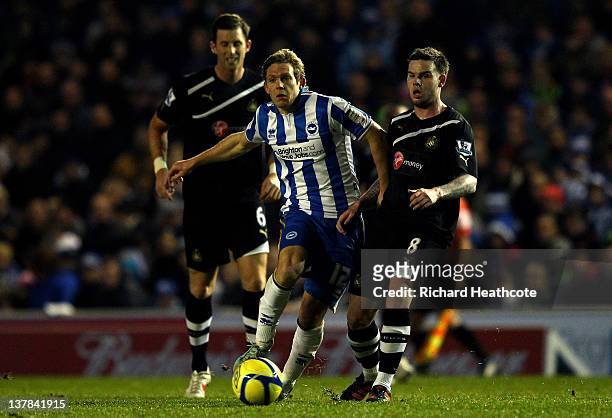 Craig Mackail-Smith of Brighton goes past the challenges from Mike Williamson and Danny Guthrie of Newcastle during the FA Cup fourth round match...