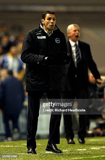 Gus Poyet the Brighton manager and Alan Pardew the Newcastle manager shout directions to their players during the FA Cup fourth round match between...