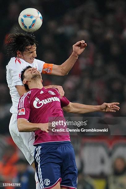 Pedro Geromel of Cologne and Ciprian Marica of Schalke jump for a header during the Bundesliga match between 1. FC Koeln and FC Schalke 04 at...