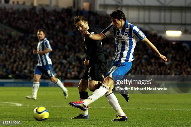 Will Buckley of Brighton scores the opening goal despite the attentions of Yohan Cabaye of Newcastle during the FA Cup fourth round match between...