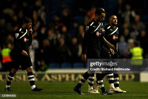 Dejected Newcastle players leave the pitch following their 1-0 defeat during the FA Cup fourth round match between Brighton and Hove Albion and...