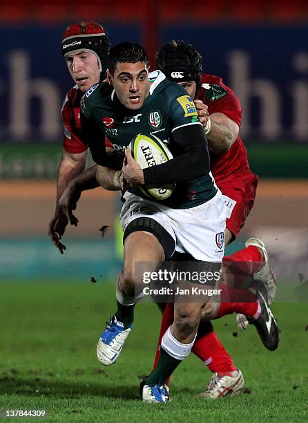 Daniel Bowden of London Irish is tackled by Dominic Day of Scarlets during the LV= Cup match between Scarlets and London Irish at Parc y Scarlets on...