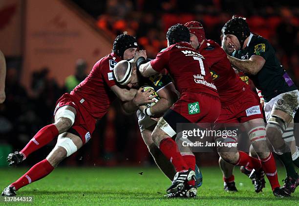 Clarke Dermody of London Irish crunches into Dominic Day of Scarlets during the LV= Cup match between Scarlets and London Irish at Parc y Scarlets on...