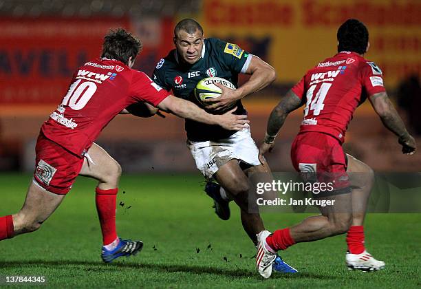 Jonathan Joseph of London Irish is tackled by Aled Thomas of Scarlets during the LV= Cup match between Scarlets and London Irish at Parc y Scarlets...