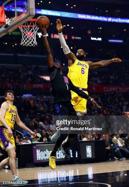LeBron James of the Los Angeles Lakers blocks the shot by Reggie Jackson of the LA Clippers in the first quarter at Crypto.com Arena on March 03,...