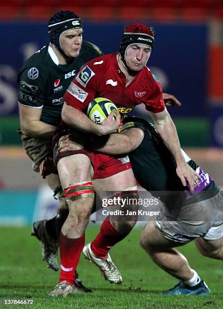 Matt Gilbert of Scarlets crashes through the tackle of Clarke Dermody of London Irish during the LV= Cup match between Scarlets and London Irish at...