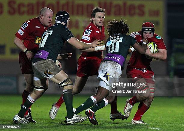 Matt Gilbert of Scarlets holds off Marland Yarde of London Irish during the LV= Cup match between Scarlets and London Irish at Parc y Scarlets on...