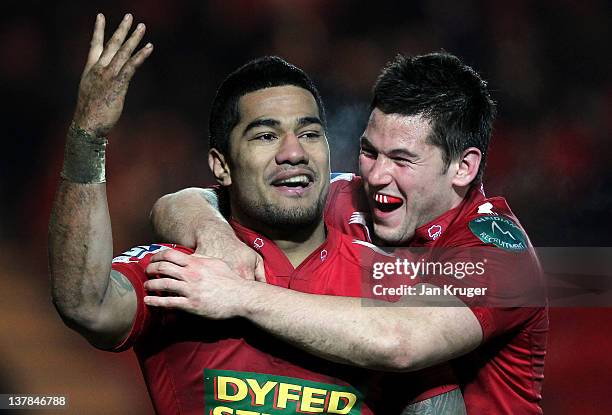 Vili longi of Scarlets celebrates his winning try with Dan Newton during the LV= Cup match between Scarlets and London Irish at Parc y Scarlets on...