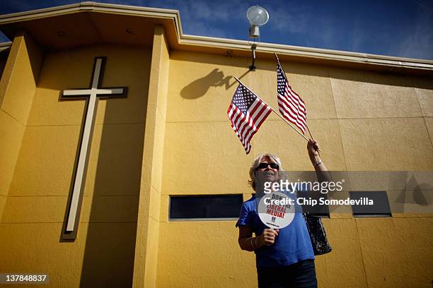 Supporter of Republican presidential candidate and former Speaker of the House Newt Gingrich waits for his arrival outside Centro de la Familia...