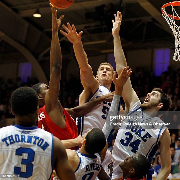 Duke forward Mason Plumlee and teammate Ryan Kelly go up to block a shot by St. John's guard Moe Harkless during the second half at Cameron Indoor...