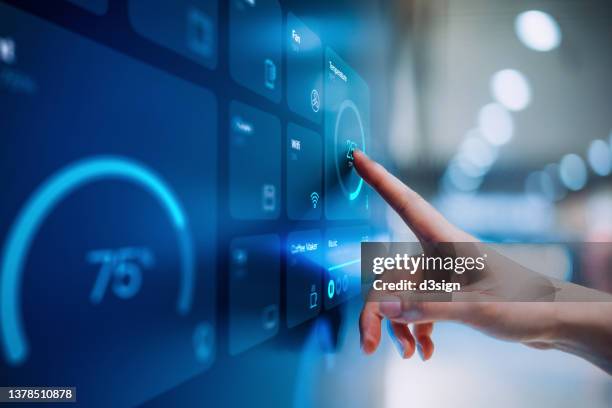 close up of woman's hand setting up intelligent home system, controlling smart home appliances with control panel of a smart home. home automated system controlled from a dashboard. smart living. lifestyle and technology. smart home technology concept - control panel stock pictures, royalty-free photos & images