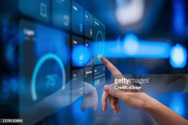 close up of woman's hand setting up intelligent home system, controlling smart home appliances with control panel of a smart home. home automated system controlled from a dashboard. smart living. lifestyle and technology. smart home technology concept - dashboard stockfoto's en -beelden