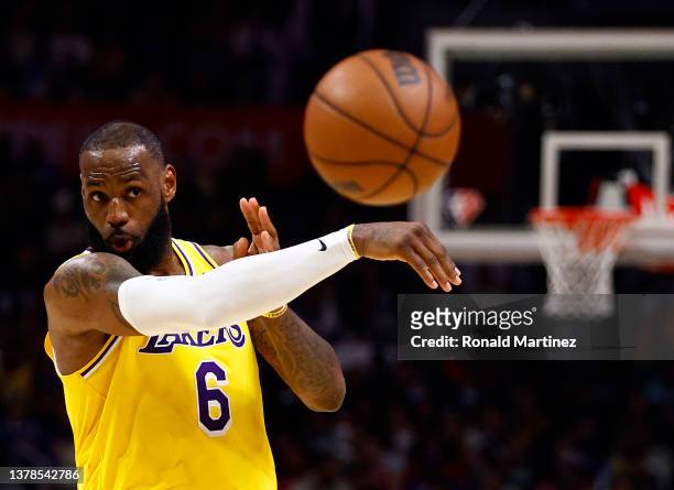 LeBron James of the Los Angeles Lakers passes the ball against the LA Clippers in the fourth quarter at Crypto.com Arena on March 03, 2022 in Los...