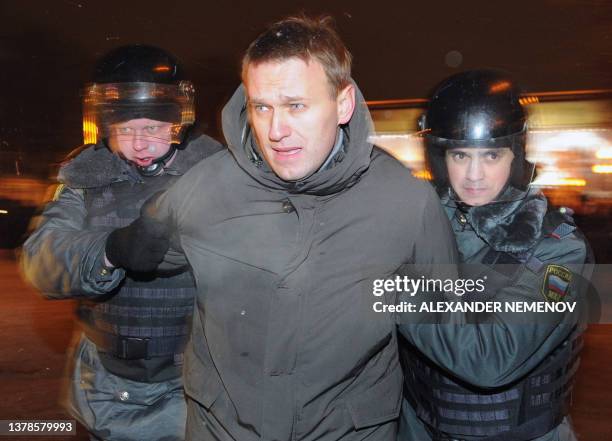 Police officers detain one of the protest movement leaders, Alexei Navalny, at Moscow's Pushkinskaya Square, on March 5 as the protesters refuse to...