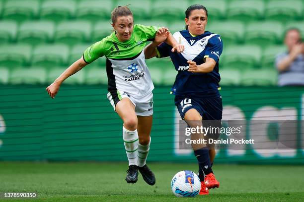 Laura Hughes of Canberra United and Alexandra Chidiac of Melbourne Victory contest the ball during the round 14 A-League Women's match between...