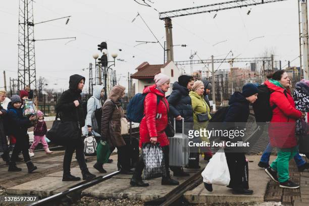 ukrainians arriving at the train station in lviv, ukraine - emigration and immigration stock pictures, royalty-free photos & images