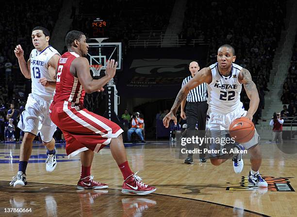 Guard Rodney McGruder of the Kansas State Wildcats drives around the guard Steven Pledger of the Oklahoma Sooners during the second half on January...
