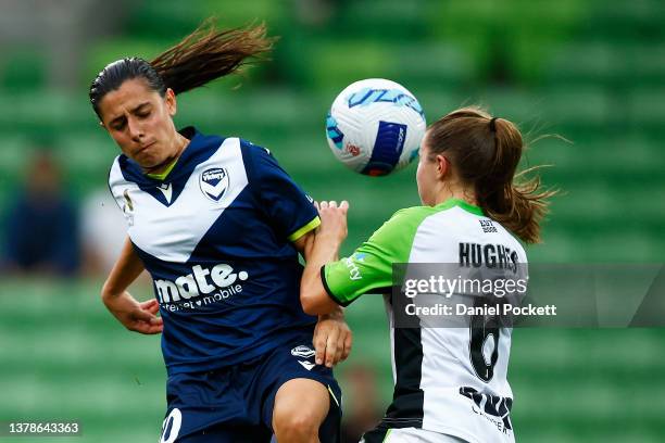 Alexandra Chidiac of Melbourne Victory and Laura Hughes of Canberra United contest the ball during the round 14 A-League Women's match between...